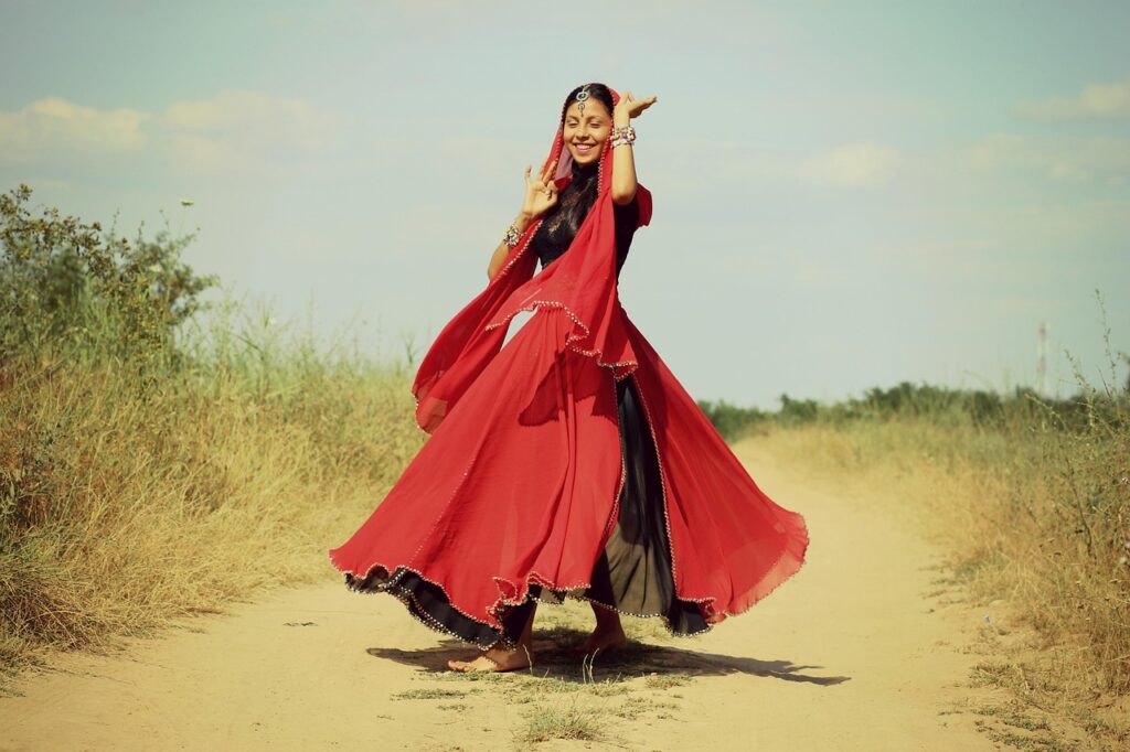 Woman dancer in a festive traditional sari showcasing oriental beauty and cultural elegance — a blend of tradition and Women’s Western Wear in Kochi.
