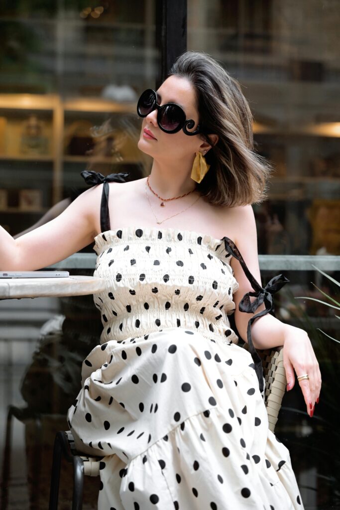 Pexels-photo-32911487 shows a fashionable woman walking confidently in a city street, blending modern street style with Ethnic Wear for Women in Kochi